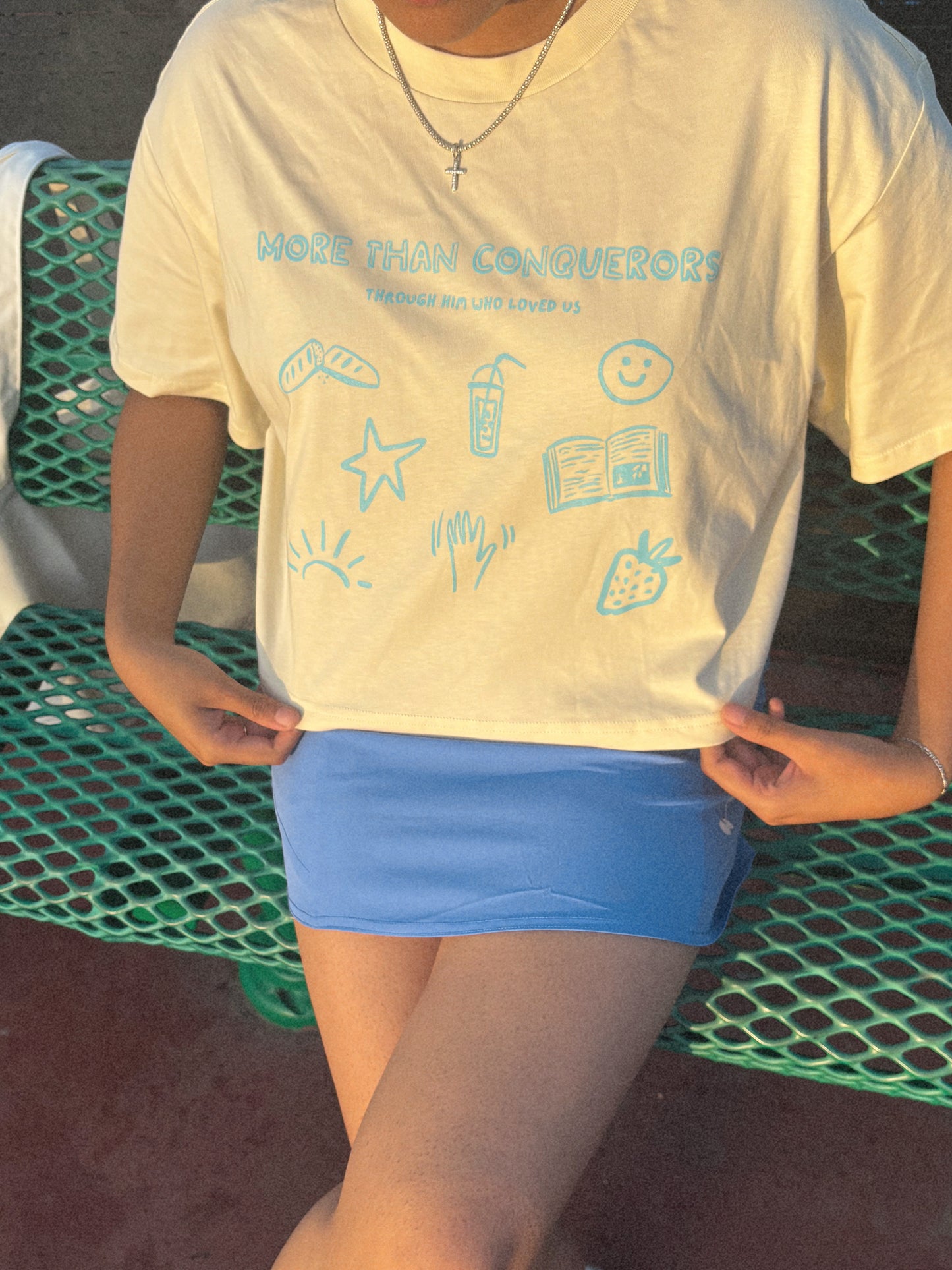 THROUGH HIM WHO LOVED US WOMEN'S CROPPED TEE